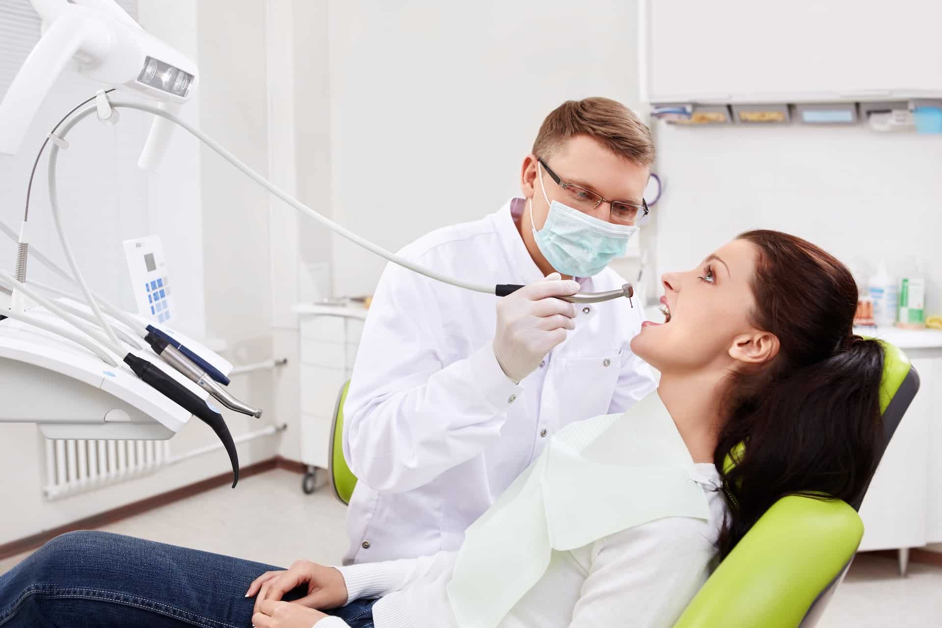 During Dental Hygiene Month, a woman receives oral care from a dental hygienist in a dentist's office