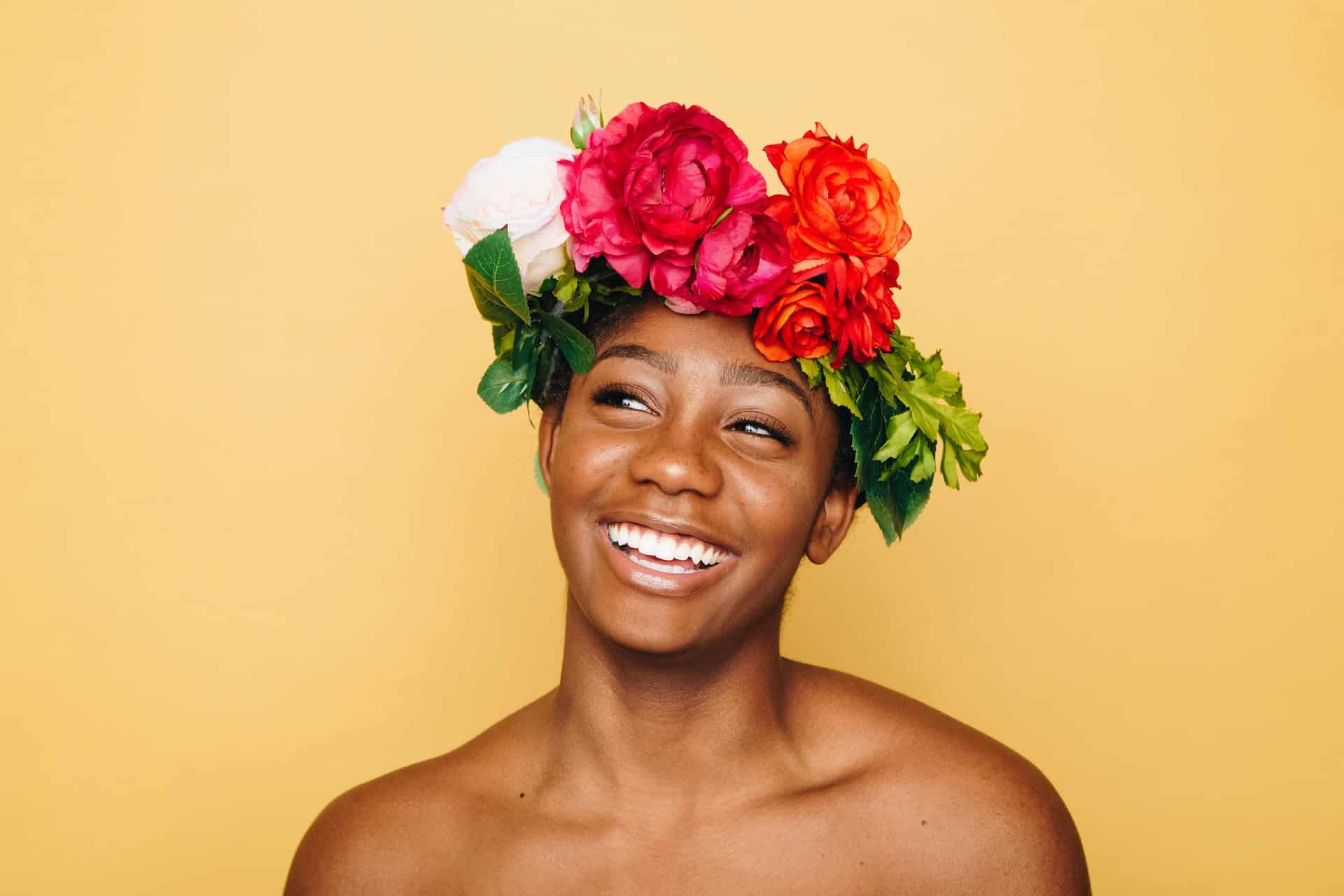 A person grins brightly, revealing the effects of teeth whitening